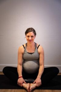pregnant person sitting in a butterfly pose
